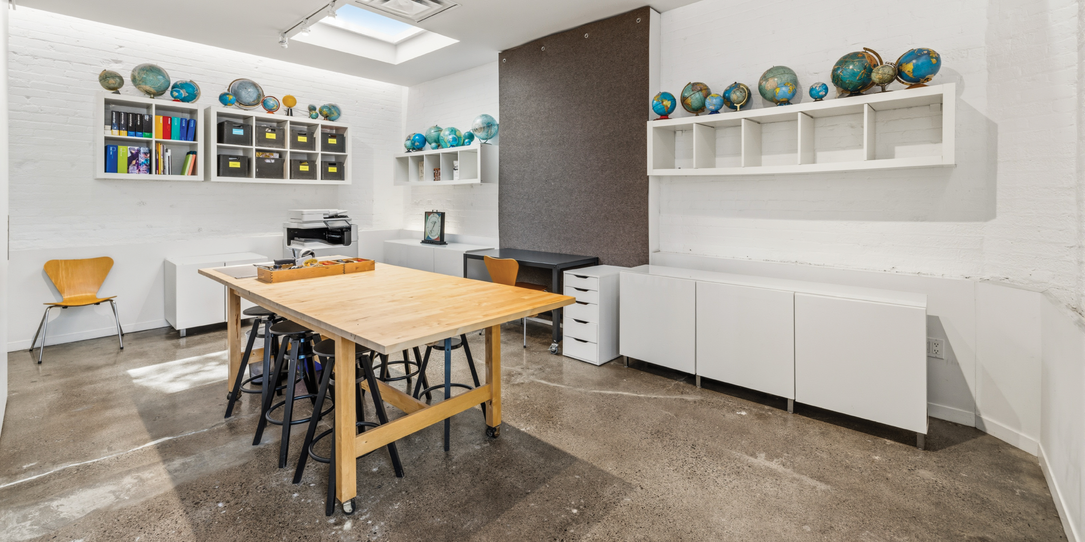 121 Logan Ave offers a bright workspace with a central worktable and storage