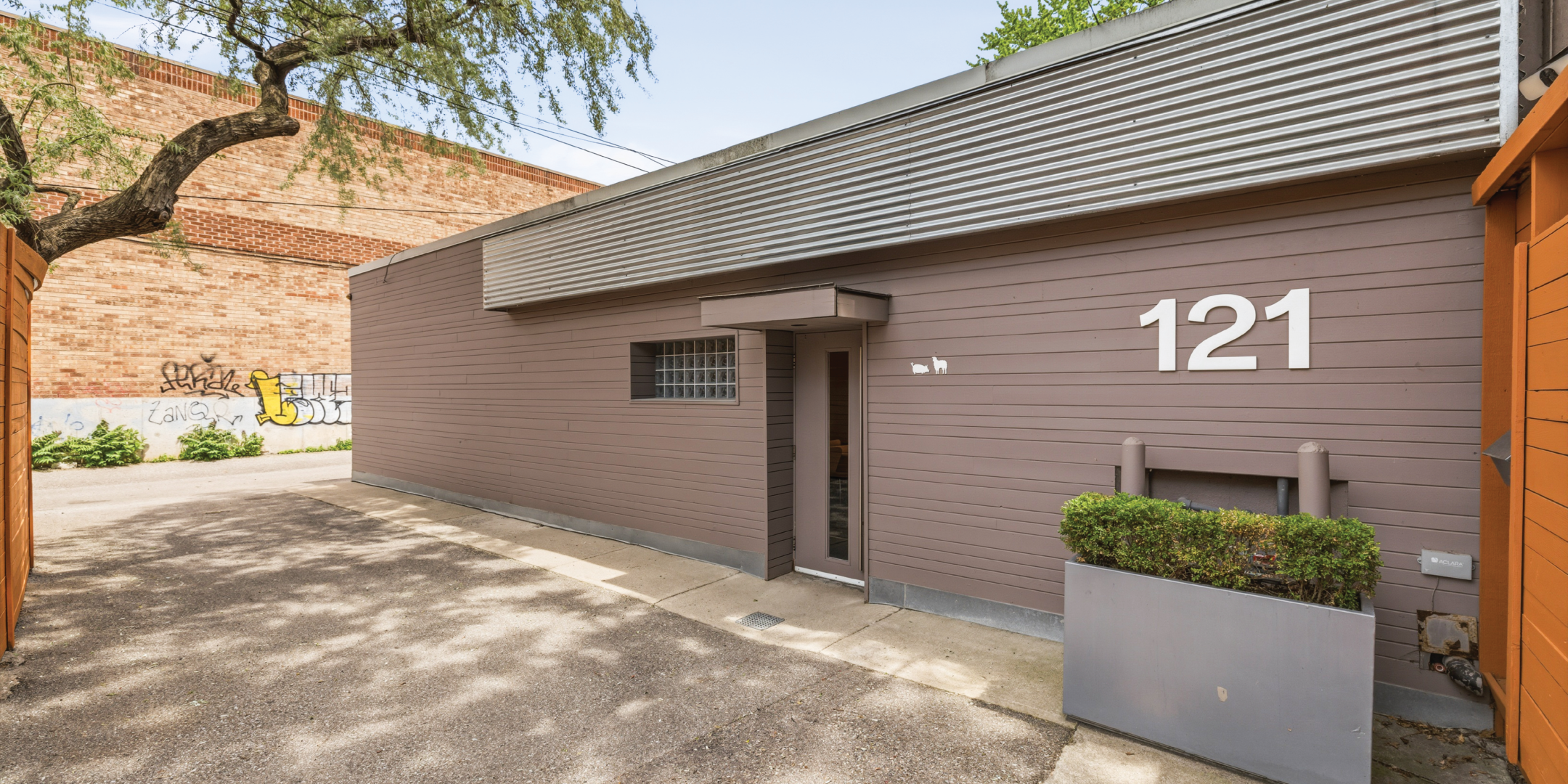 121 Logan Ave showcases a modern industrial exterior with private parking access