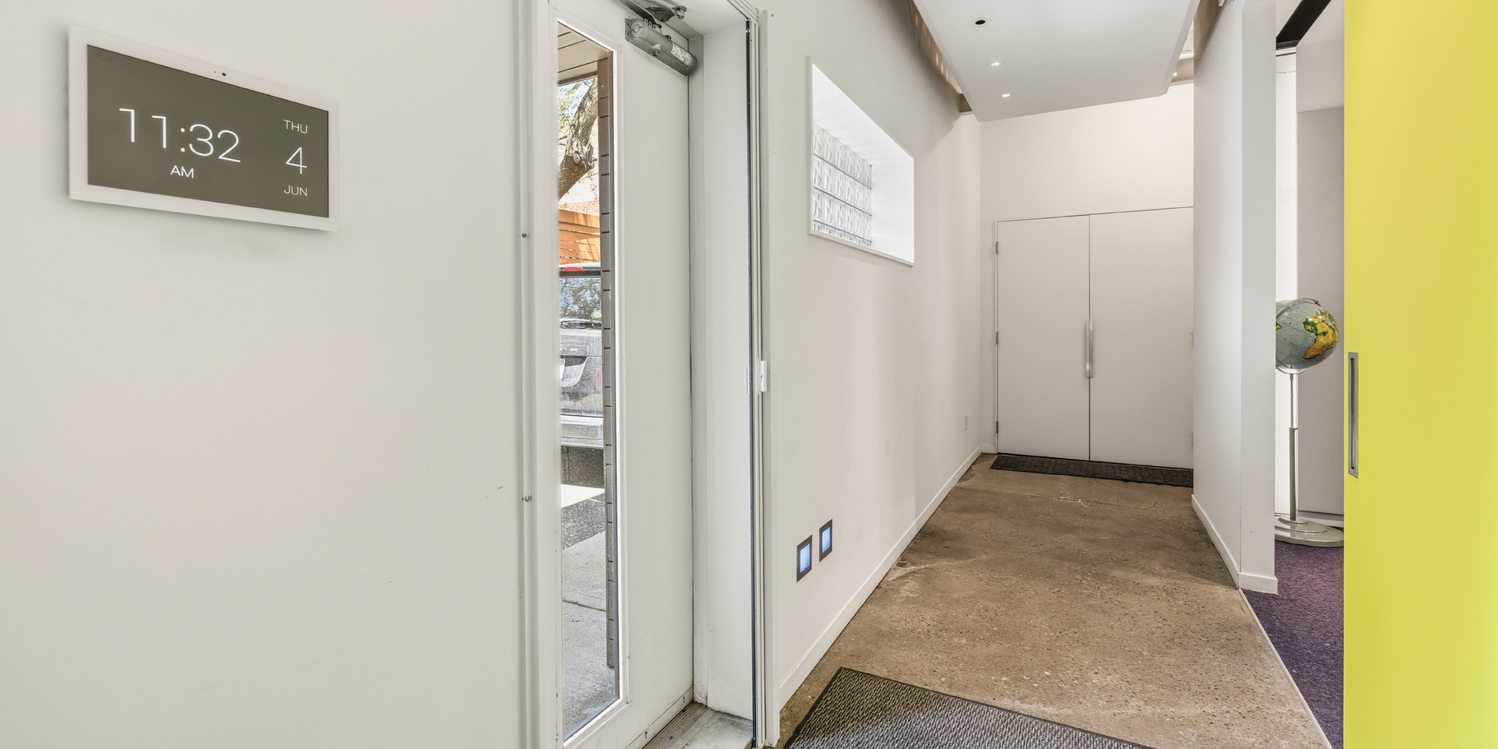121 Logan Ave welcomes visitors with a bright entry corridor and polished concrete floors