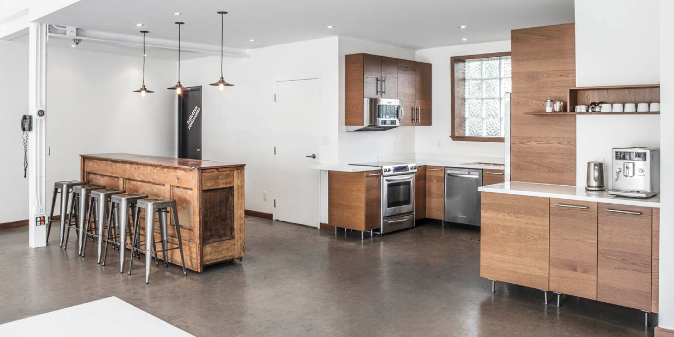 1444 Dupont Street full kitchen with a window overlooking the cabinet and appliances
