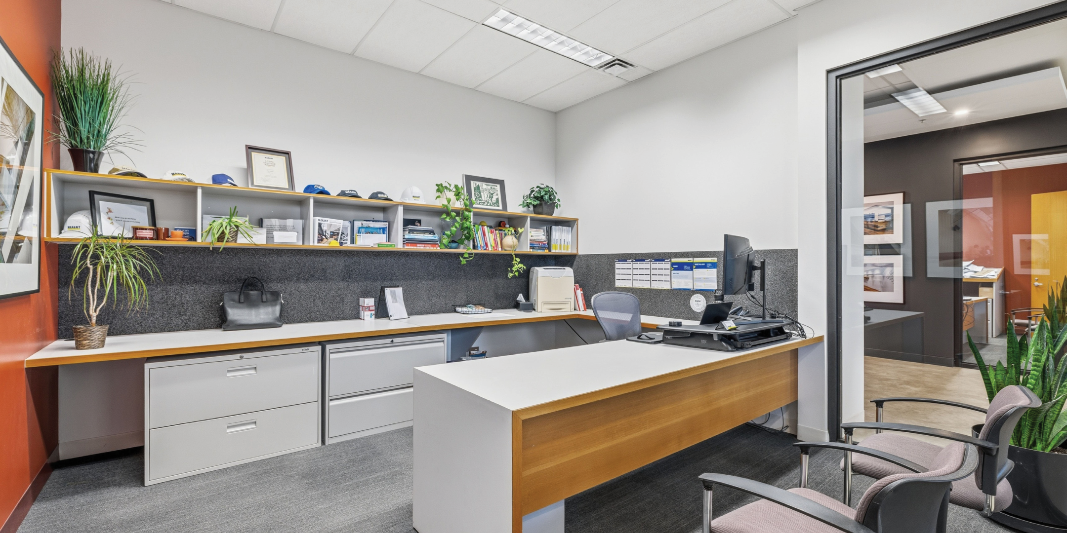 private office with white furniture, grey chairs, white walls with glass internal walls