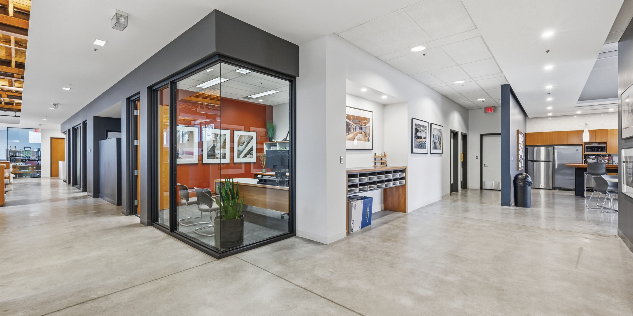 open area with light grey tile flooring, bright lighting, white walls and dark grey accents