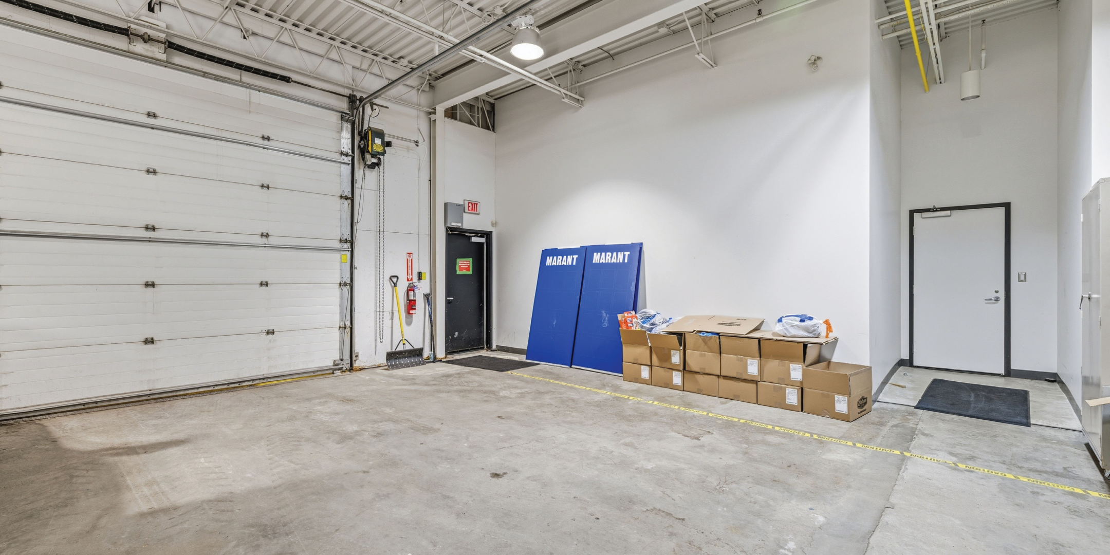 warehouse area with shipping door and white walls