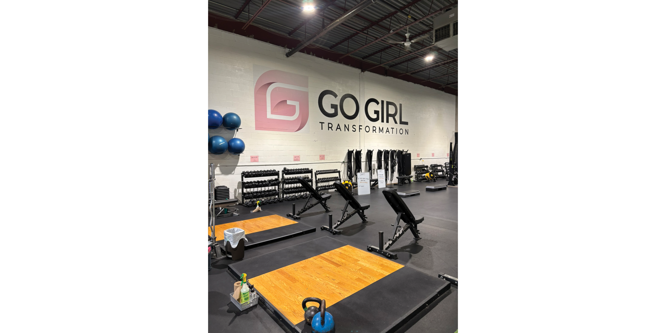 fitness facility with grey floor mats, exposed ceiling and fitness equipment