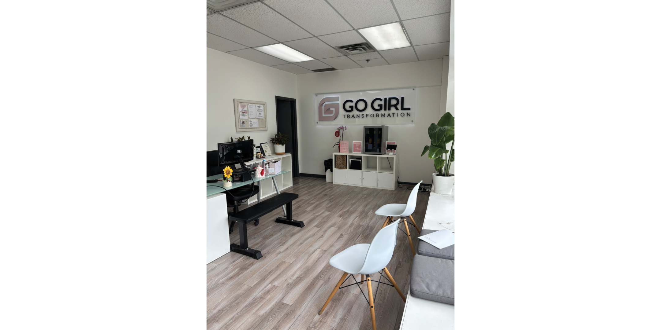 reception area to fitness facility with grey flooring and white walls