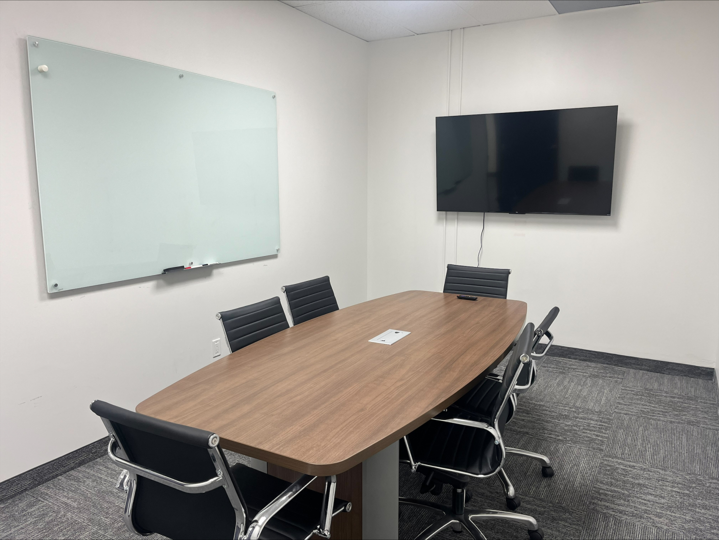 4190 South Service Road Boardroom with TV, desk and whiteboard