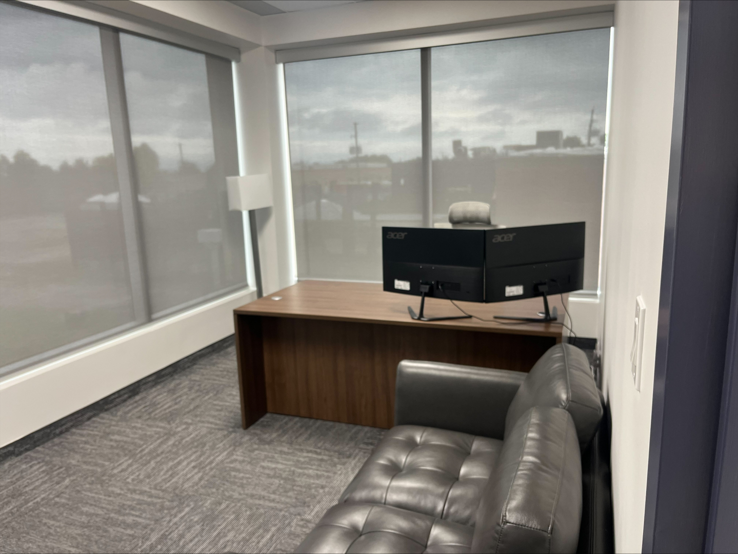 4190 South Service Road Corner office with big windows overlooking the desk and sofa