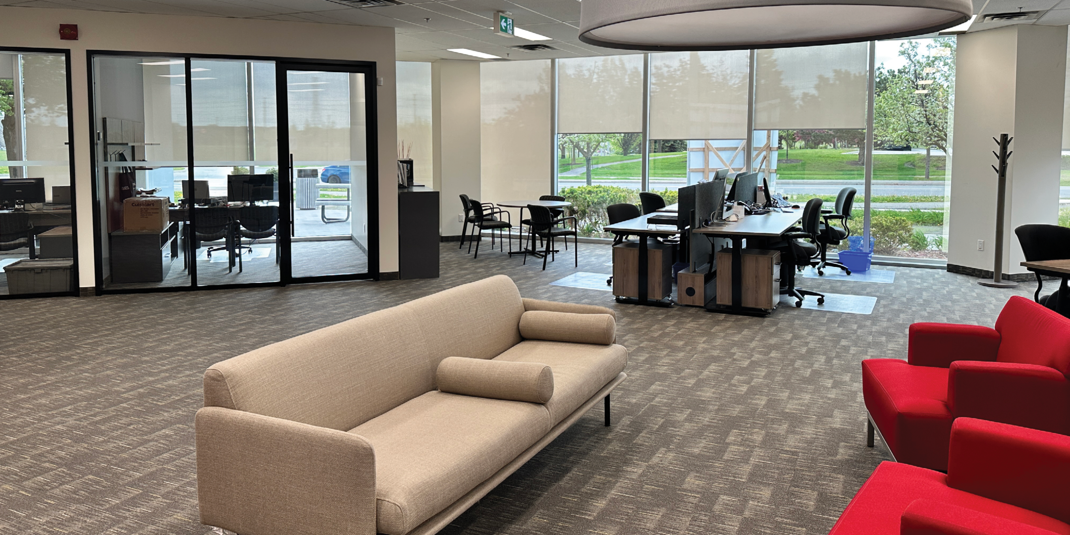 5090 Explorer Dr open concept reception and collaborative workspace with floor to ceiling windows.