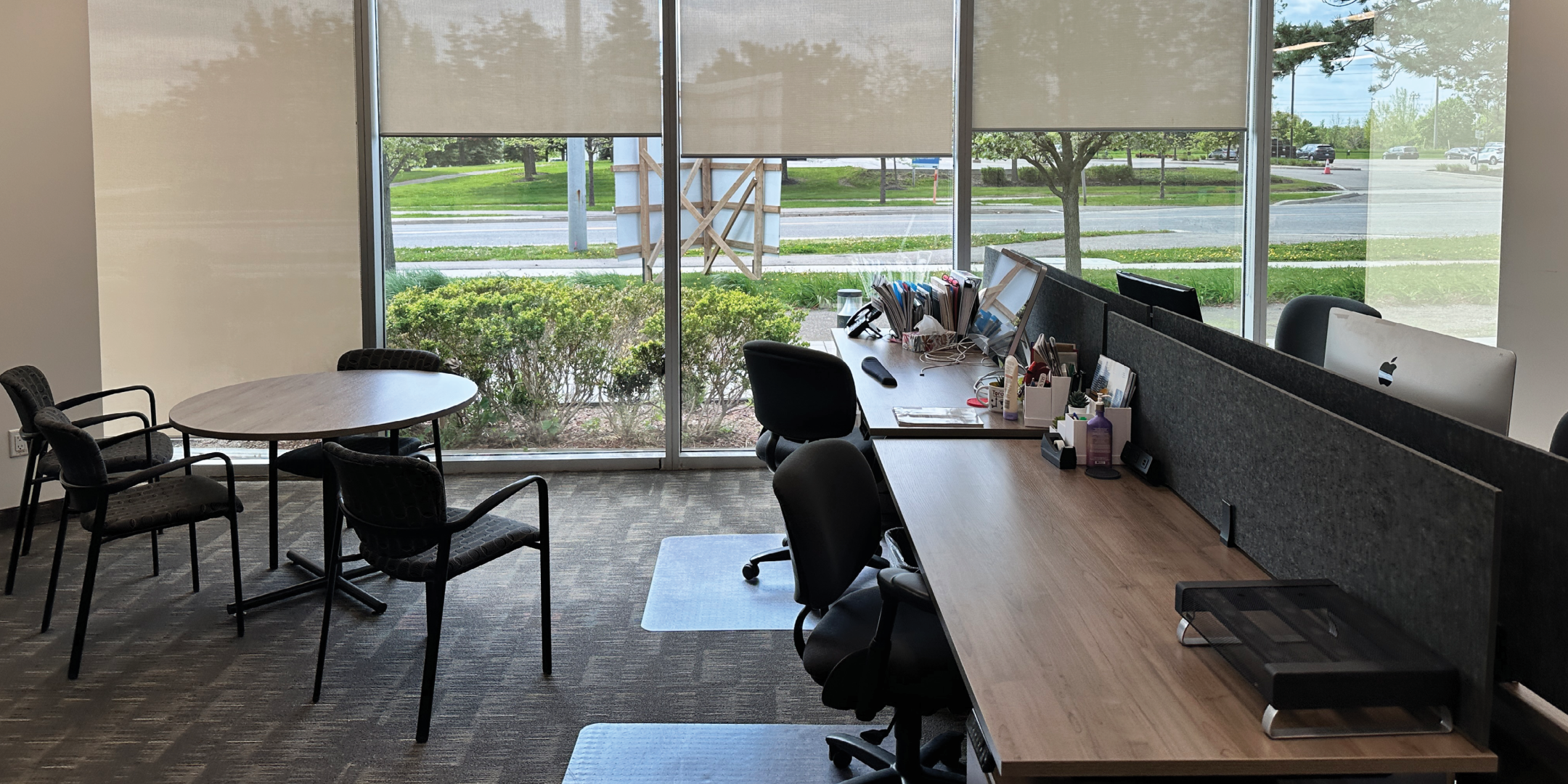 5090 Explorer Dr workstation area with natural light and meeting table.