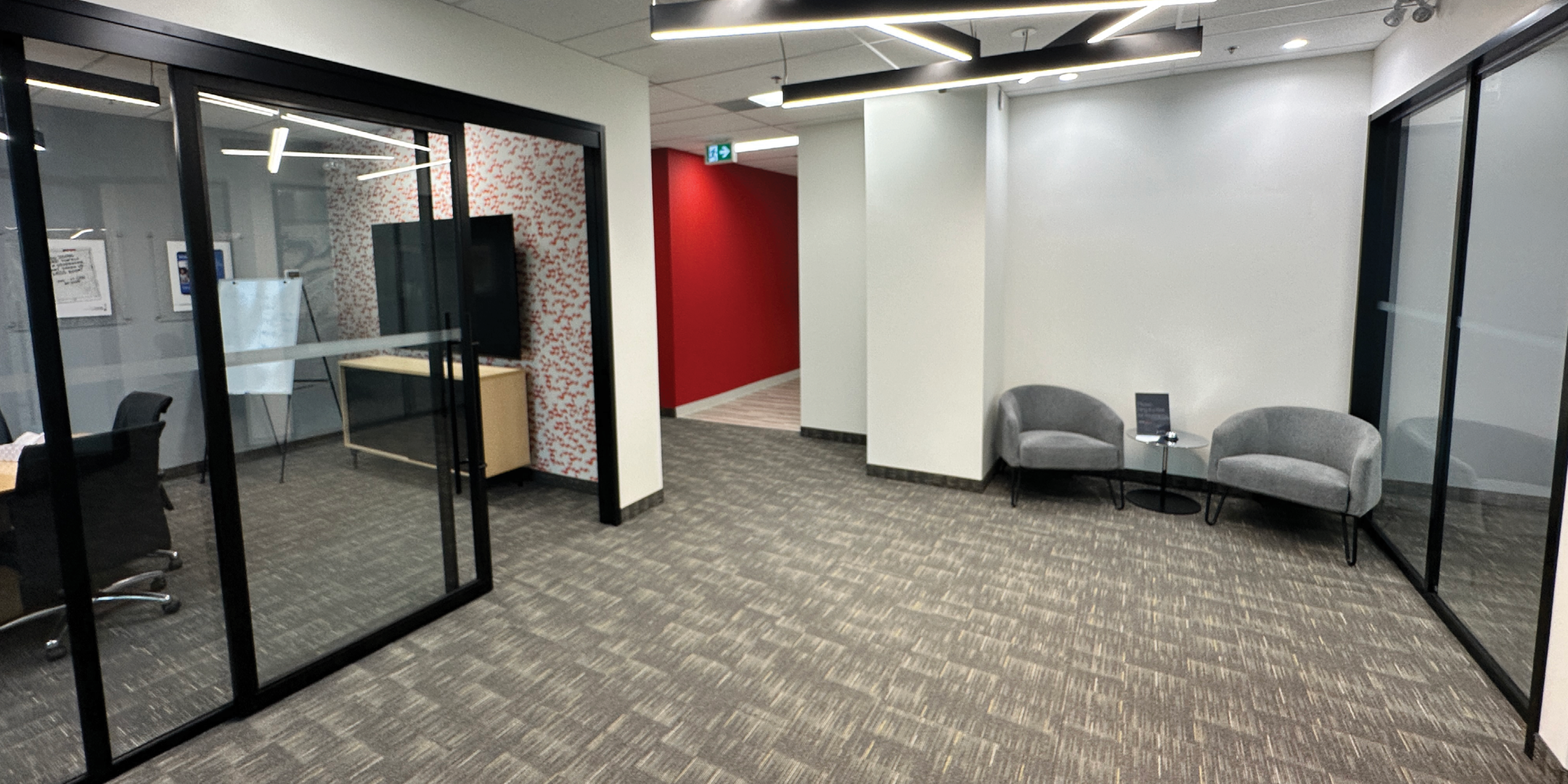 5090 Explorer Dr modern lobby with glass enclosed offices and seating area.