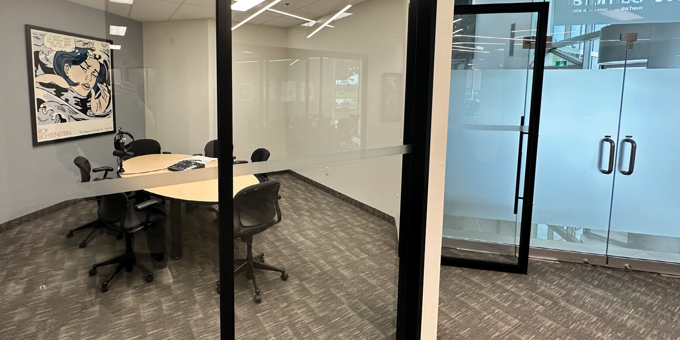 5090 Explorer Dr private boardroom with large conference table and exterior views.