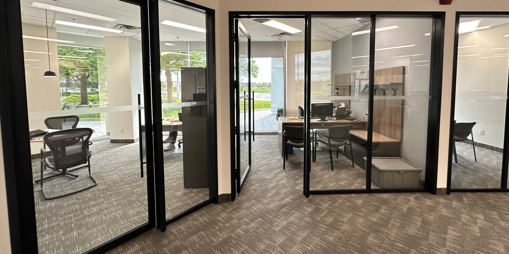 5090 Explorer Dr private office with built in workstation and exterior windows.