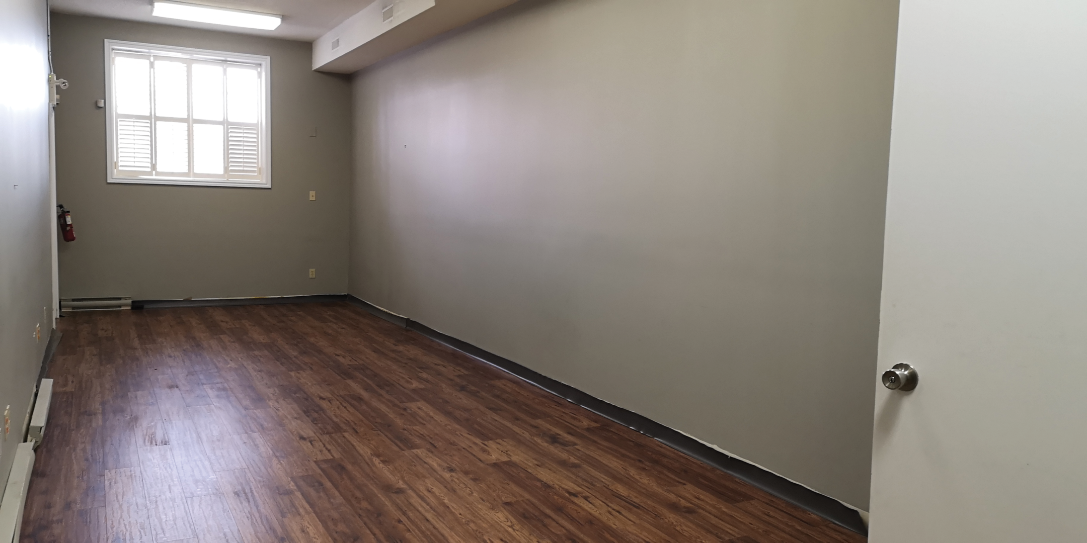 28 Main Street N Room with large window and hardwood floors