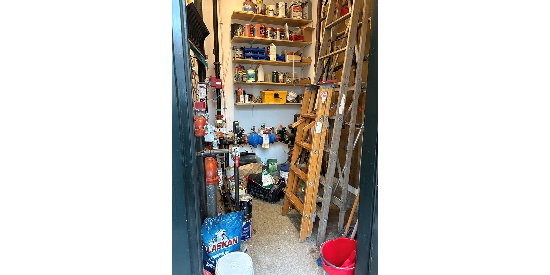 Storage room filled with various equipment such as paint cans and ladders