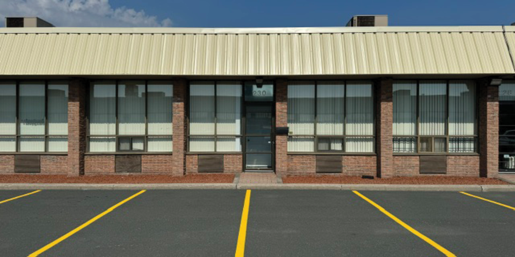  Front exterior of 230 Wildcat Road with empty parking spots
