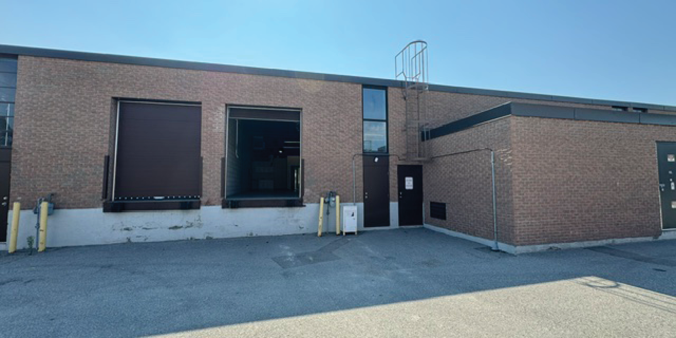 Back exterior of 230 Wildcat Road showing shipping doors