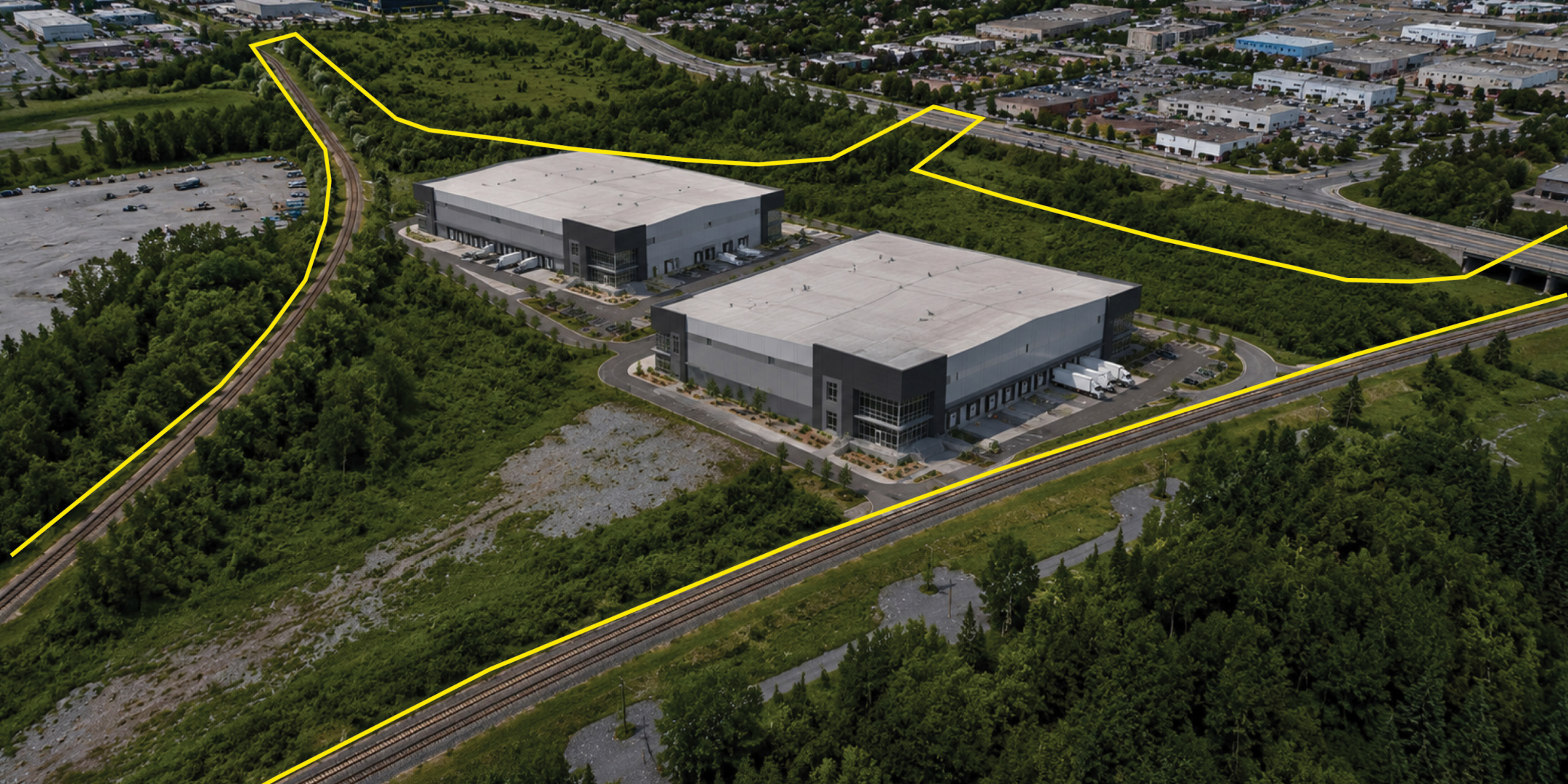 Aerial View of 2670 Walkley Road, with a yellow property outline and renderings of two potential industrial buildings