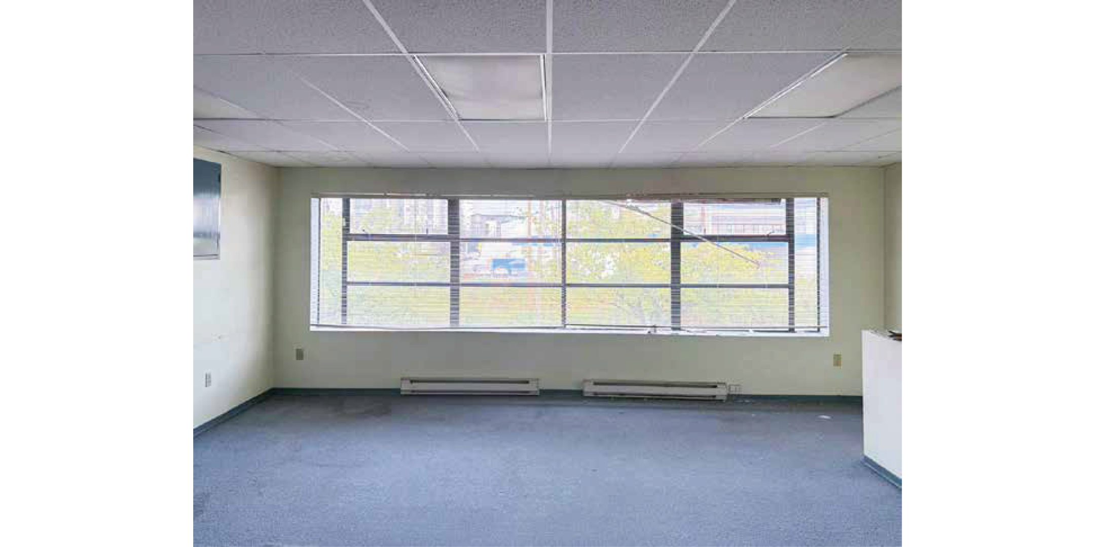 9012 Oak Street building interior showing large window and open workspace