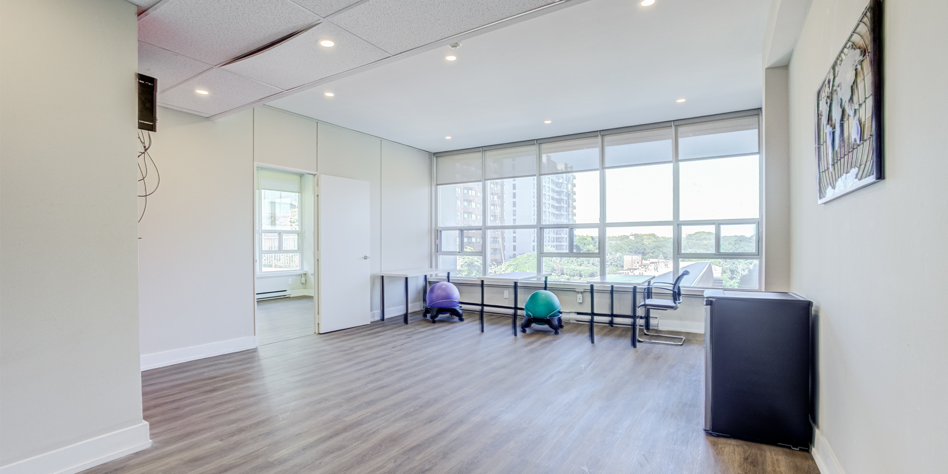 Space with multiple tables and chairs with huge windows 802-60 Pleasant Boulevard 