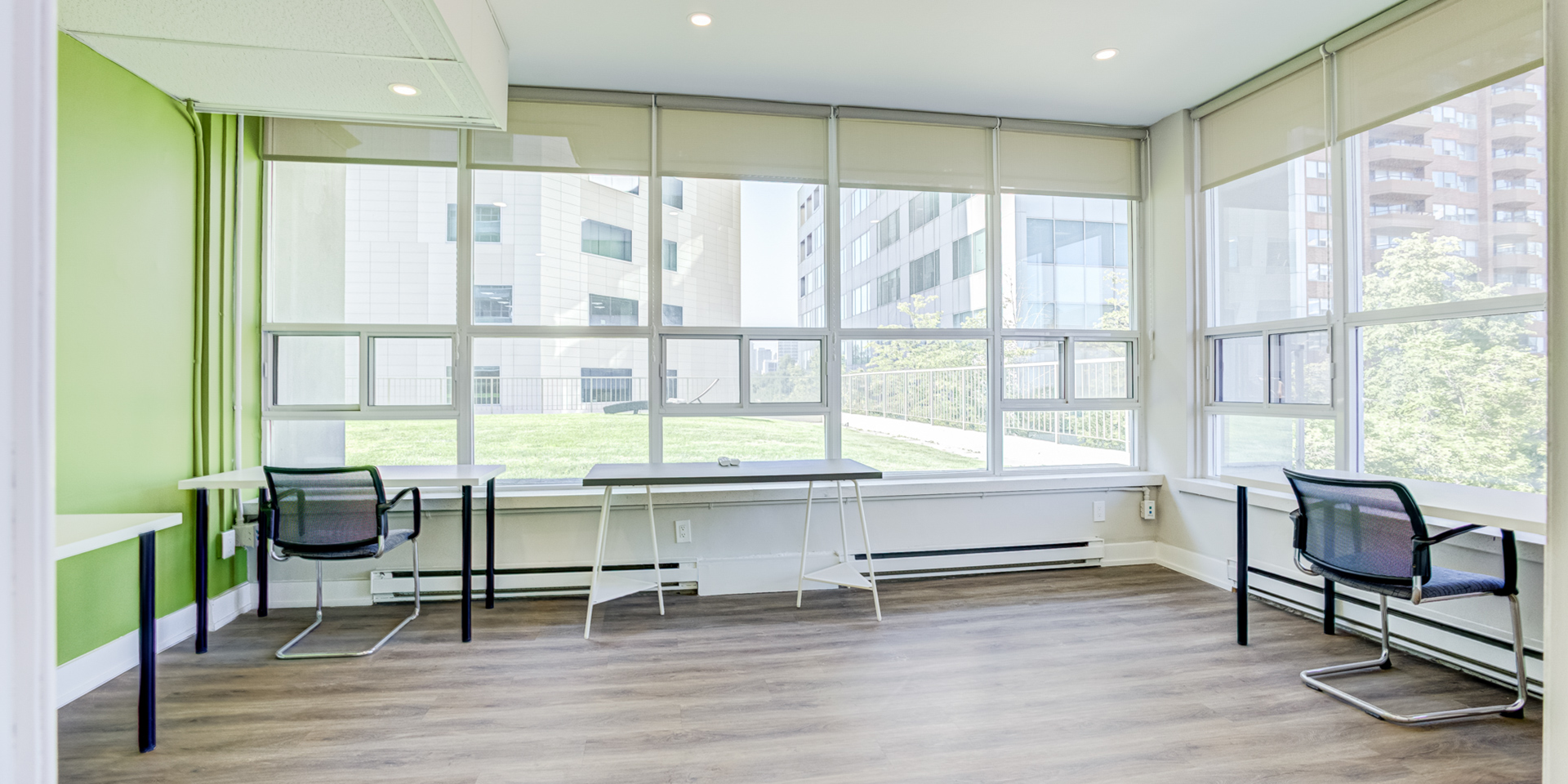 Another space with few tables and chairs and a huge windows 802-60 Pleasant Boulevard 