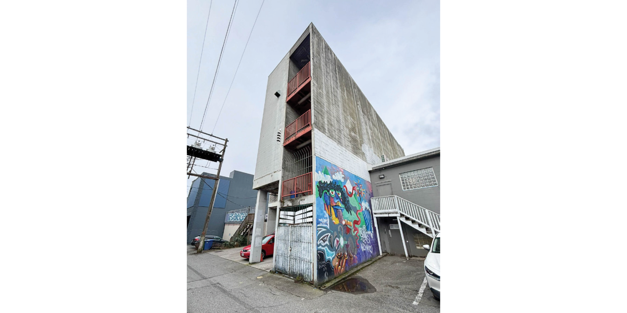62 West 8th Avenue building exterior showing rear parking and stairwell