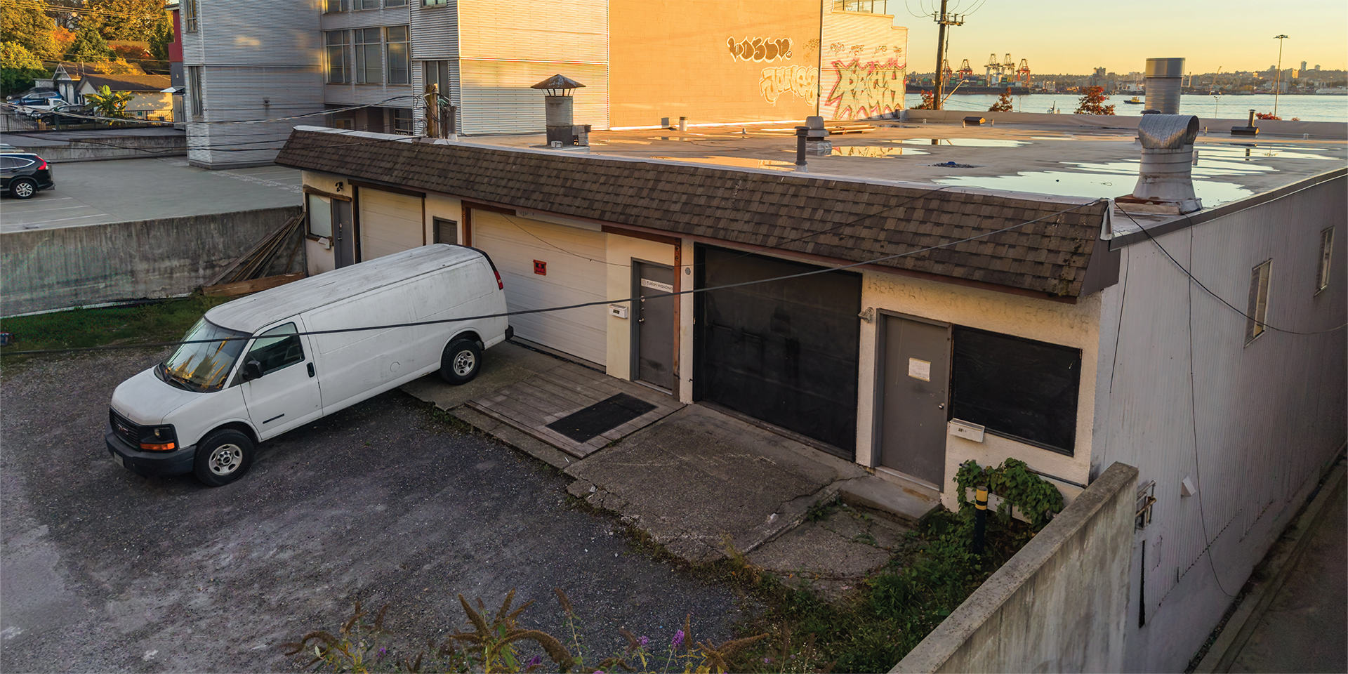 360B East Esplanade building exterior showing rear loading area and parking