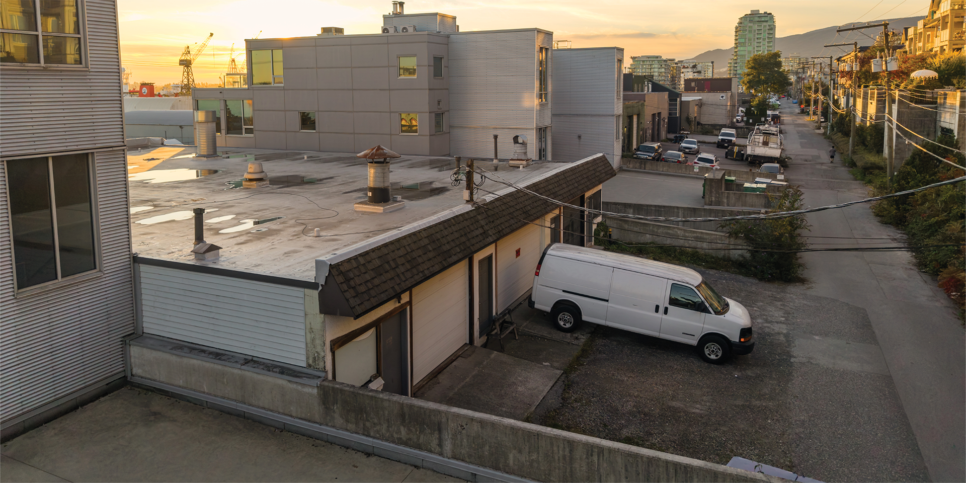 360B East Esplanade building exterior showing rear loading area and parking