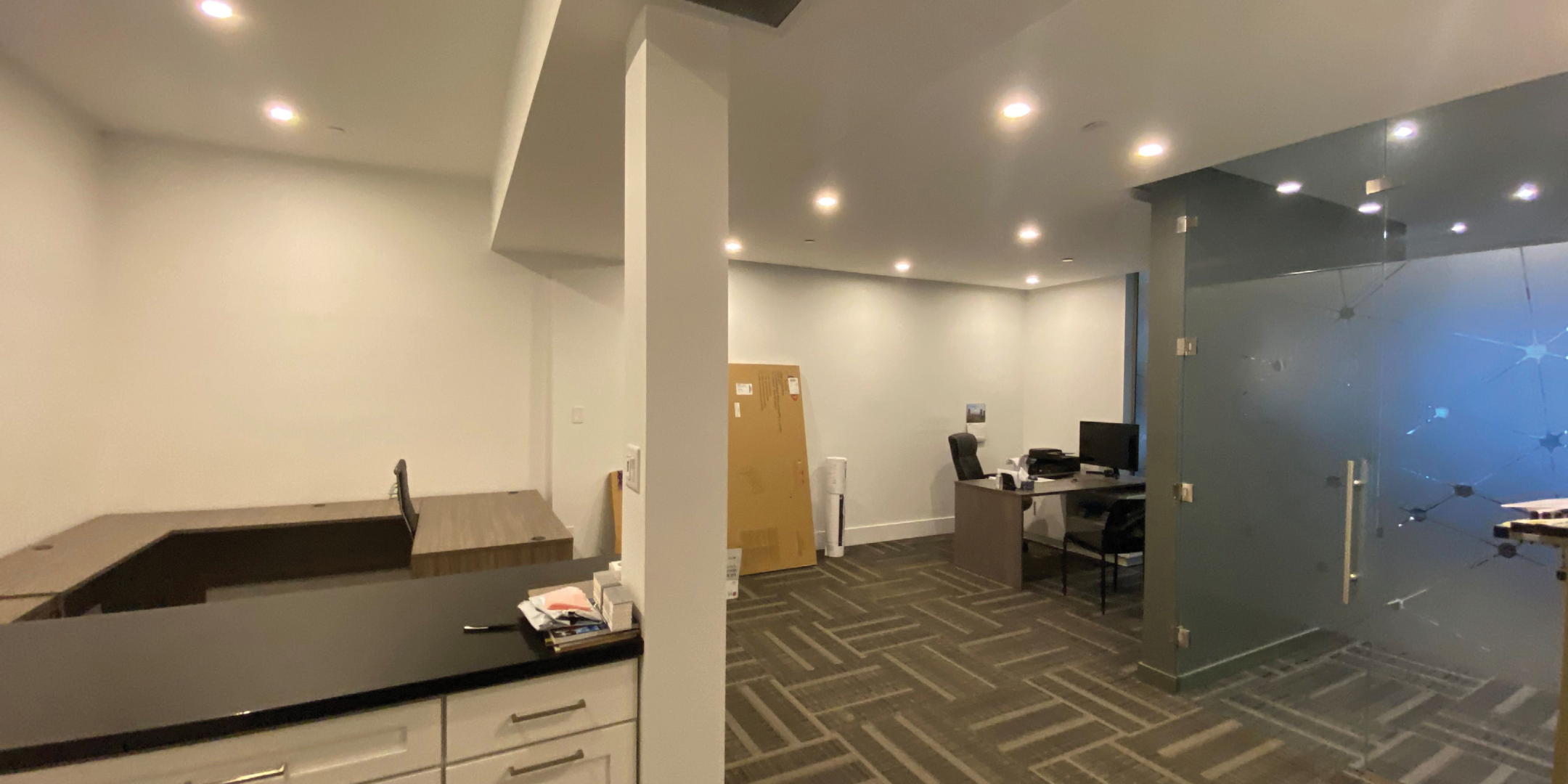 open area with cabinets and glass meeting area