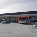 Photo of front entrance of salon unit in multi unit outdoor strip plaza