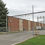 1125 Burns Street E building exterior with outer gate